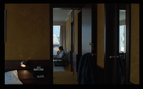 Paul in his apartment with opera singing in the background.