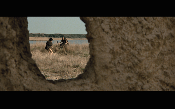 A fight is framed through a hole.